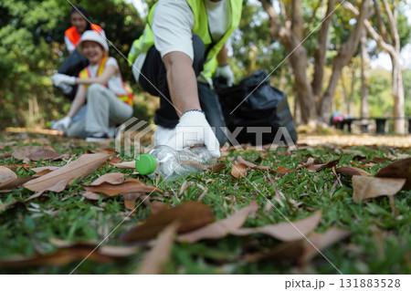 Environmental Responsibility. A volunteer collects plastic waste as part of a community effort to promote sustainability and a cleaner habitat. Environmental Responsibility. A volunteer collects plastic waste as part of a community effort to promote sustainability and a cleaner habitat. 131883528