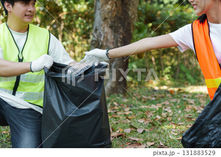 Team Efforts for a Cleaner Environment. Volunteers work together to collect plastics, strengthening community ties through environmental efforts. 131883529
