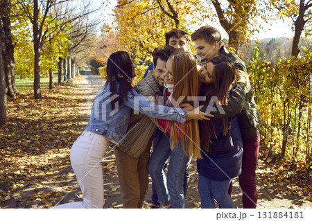 Group of happy young friends having fun in autumn park. Group of happy young friends having fun in autumn park. 131884181