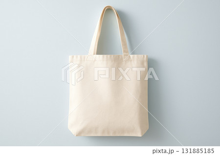Minimalist beige cotton tote bag with handles on light background emphasizing eco friendly and reusable shopping solutions, AI Generative 131885185