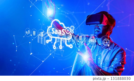Man Interacting with Virtual Reality Technology in Blue Neon Environment with Software Conceptual Icons and Cloud Computing Graphics. Raster Man Interacting with Virtual Reality Technology in Blue Neon Environment with Software Conceptual Icons and Cloud Computing Graphics. Raster 131888030