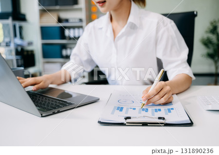 Businesswoman or accountant hand typing laptop working to calculate on desk about cost at office. Businesswoman or accountant hand typing laptop working to calculate on desk about cost at office. 131890236