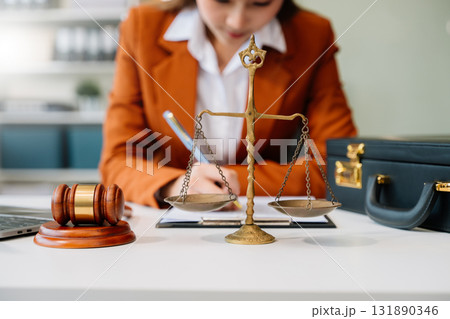 justice and law concept. Male judge in a courtroom the gavel, working with smart phone and laptop and digital tablet 131890346