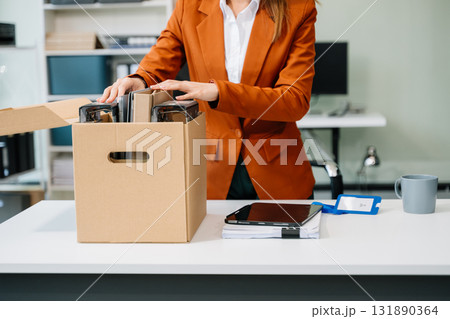 Happy and excited young beautiful Asian woman office worker celebrating her resignation, carrying her personal stuff. Happy and excited young beautiful Asian woman office worker celebrating her resignation, carrying her personal stuff. 131890364