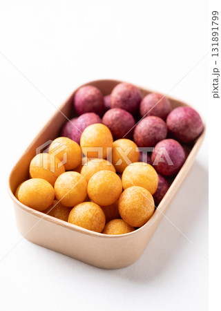Deep fried sweet potato balls in paper box on white background, Thai street food snack Deep fried sweet potato balls in paper box on white background, Thai street food snack 131891799