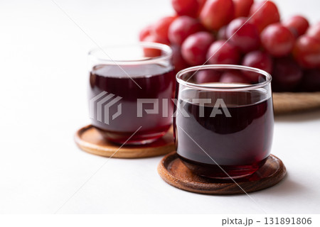 Red grape juice in glass and fresh grapes fruit on white background, Healthy drink Red grape juice in glass and fresh grapes fruit on white background, Healthy drink 131891806