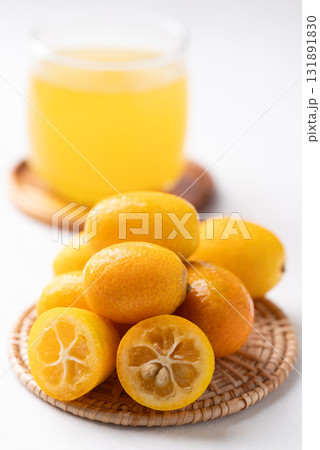 Fresh kumquats fruit and juice on white background Fresh kumquats fruit and juice on white background 131891830