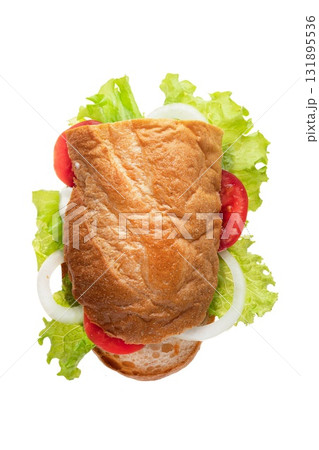 Fresh sandwich with lettuce, tomato, and onion on a soft bread bun arranged on a clean surface Fresh sandwich with lettuce, tomato, and onion on a soft bread bun arranged on a clean surface 131895536