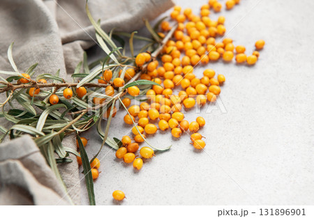 Sea buckthorn berries spilled on gray background 131896901