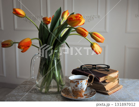 Classic still-life with books and tulips and a cup of tea 131897012