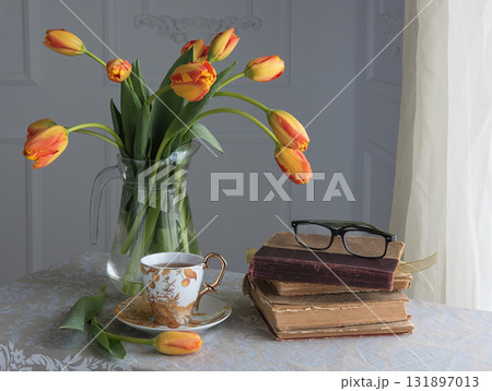 Classic still-life with books and tulips and a cup of tea Classic still-life with books and tulips and a cup of tea 131897013