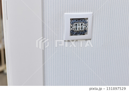 unfinished electrical switch installation on wall at home, close-up unfinished electrical switch installation on wall at home, close-up 131897529