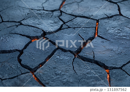 Cracked Earth with Fiery Glow, Dried Soil Texture in a Dramatic Black Surface 131897562