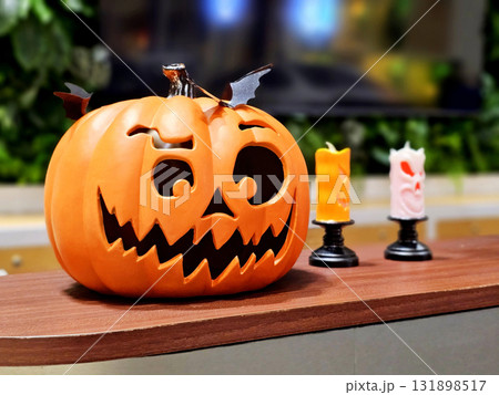 Halloween Jack o lantern and spooky candles on a wooden table. Halloween Jack o lantern and spooky candles on a wooden table. 131898517