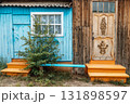 colorful wooden house facade with vibrant blue and orange steps in rural setting. closeup. 131898597