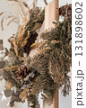elegant dried flower wreath displayed on wooden frame in bright room setting. closeup. 131898602