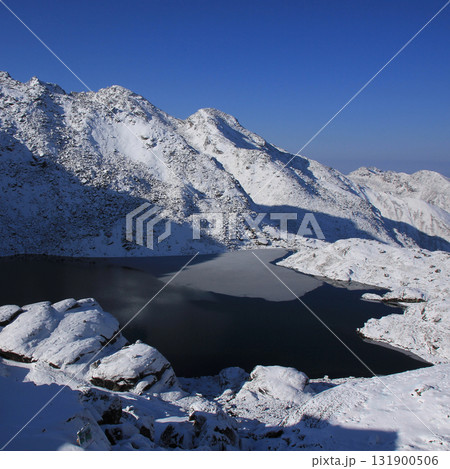 Lake Bhairabkunda, lake near Gosainkunda, Nepal. Spring morning with new snow. 131900506