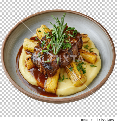 Braised Veal Cheek with Madeira Glaze and Smoked Celery Root Mash On a Plate Garnished with Fresh Herbs 131901869