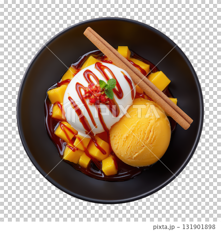 Vibrant Orange Mango Sorbet Garnished with Fresh Mango Cubes and Drizzled with Chili Honey in a Black Bowl 131901898