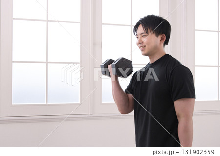 ダンベルで筋トレをする20代男性 131902359