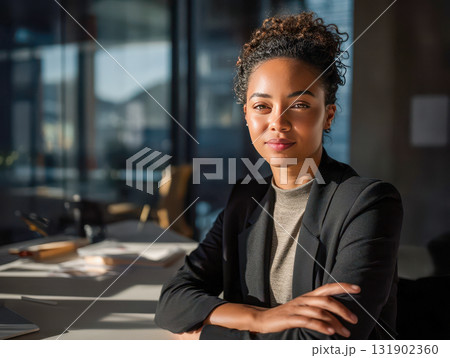 Confident businesswoman sitting at modern office desk, professional portrait of female executive in natural light 131902360