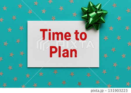 Time to plan message on white card with bold red text placed on turquoise background scattered with silver star confetti and green gift bow for celebration and resolution 131903223