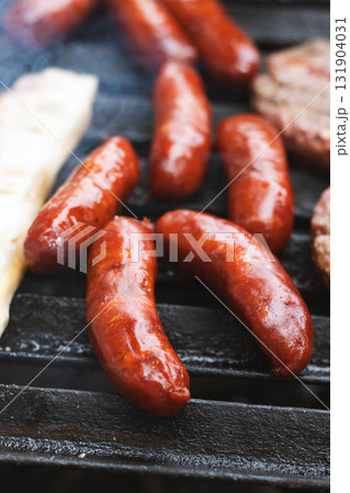 Grilled chorizo sausages on barbecue 131904031