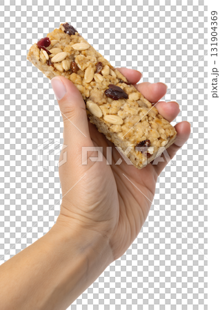 Hands holding healthy oat and nut granola bar, nutritious on-the-go snack isolated on transparent background 131904369