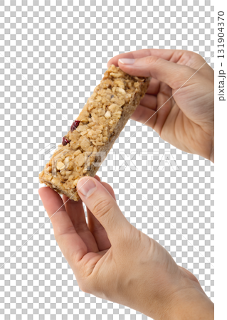 Hands holding healthy oat and nut granola bar, nutritious on-the-go snack isolated on transparent background Hands holding healthy oat and nut granola bar, nutritious on-the-go snack isolated on transparent background 131904370