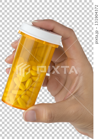 Hand holding yellow prescription pill bottle with white cap, pharmacy and medication adherence concept, isolated on transparent background 131904372
