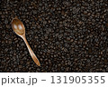 a hint of subtle taste and the ability to enjoy the taste of coffee alone or with friends, these coffee beans are on spoons and scattered on the surface as a background 131905355