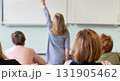 Back view of older student raising his hand to answer teacher's question during education training class. jpg ai image 131905462