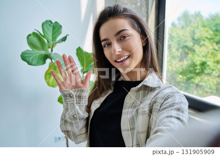Close-up selfie portrait of teenage female looking at web camera 131905909