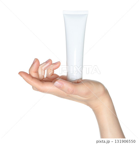 Hand holding white blank cosmetic cream tube isolated on transparent background 131906550