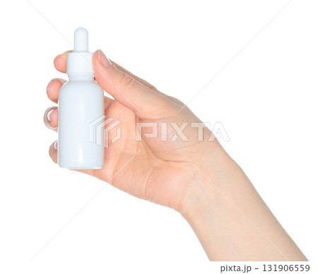 Human hand holding white cosmetic bottle isolated on transparent background 131906559