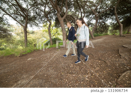 Young couple walking along a natural park path 131906734