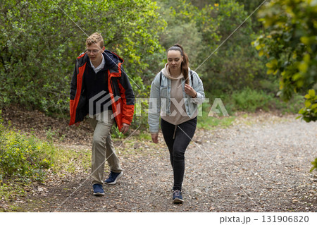 Young couple hiking path exploring green forest 131906820