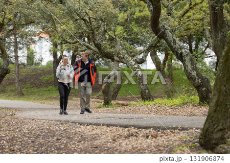 Couple walking in park enjoying nature together 131906874