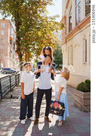 Children enjoy a sunny day outside with friends and family in the city 131906946
