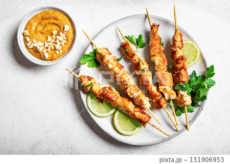 Malaysian chicken satay skewers with peanut sauce Malaysian chicken satay skewers with peanut sauce 131906953
