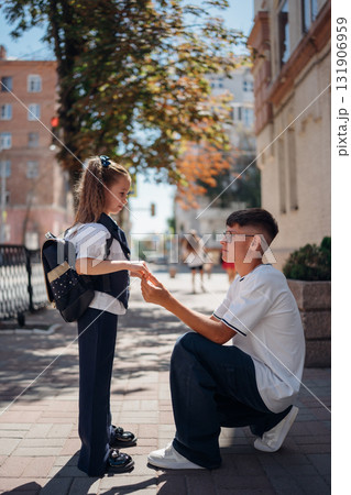 Kids exchanging gifts on a sunny street during a school day 131906959