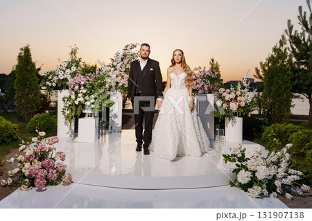 Gentle and happy bride and groom at sunset on the riverbank. Romantic. 131907138