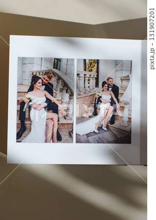 page of an open photo book with wedding photos on a white table 131907201