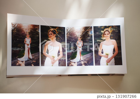 an open photo book with wedding photos on a white table an open photo book with wedding photos on a white table 131907266