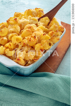 Mac and Cheese, homemade macaroni pasta, oven-baked in a casserole with cream Mac and Cheese, homemade macaroni pasta, oven-baked in a casserole with cream 131908000