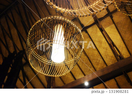 Beautiful rattan lamp hanging on wooden ceiling in tropical resort in Thailand. Travel in Asian Beautiful rattan lamp hanging on wooden ceiling in tropical resort in Thailand. Travel in Asian 131908281