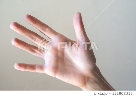 A close-up of a human hand with fingers extended, palm facing forward. The hand is light-skinned with visible details of the fingers and palm. 131908313