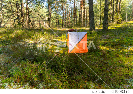A prism marker and electronic composter at an orienteering control point 131908350