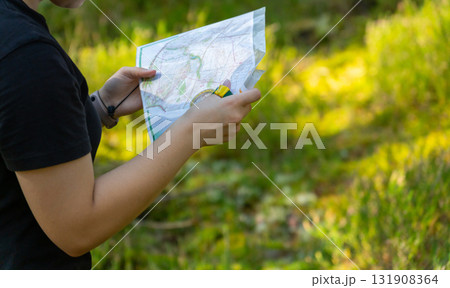 Orienteering athlete running through a summer forest with a map and compass. Orienteering athlete running through a summer forest with a map and compass. 131908364