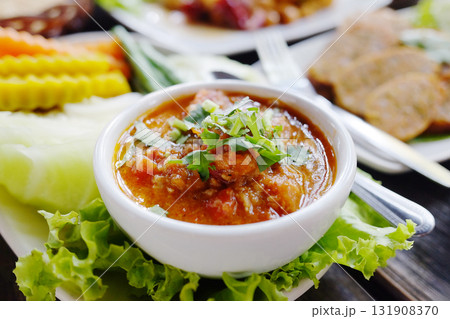 Delicious spicy northern Thai pork and tomato in white bowl. Traditional of Thai food Delicious spicy northern Thai pork and tomato in white bowl. Traditional of Thai food 131908370